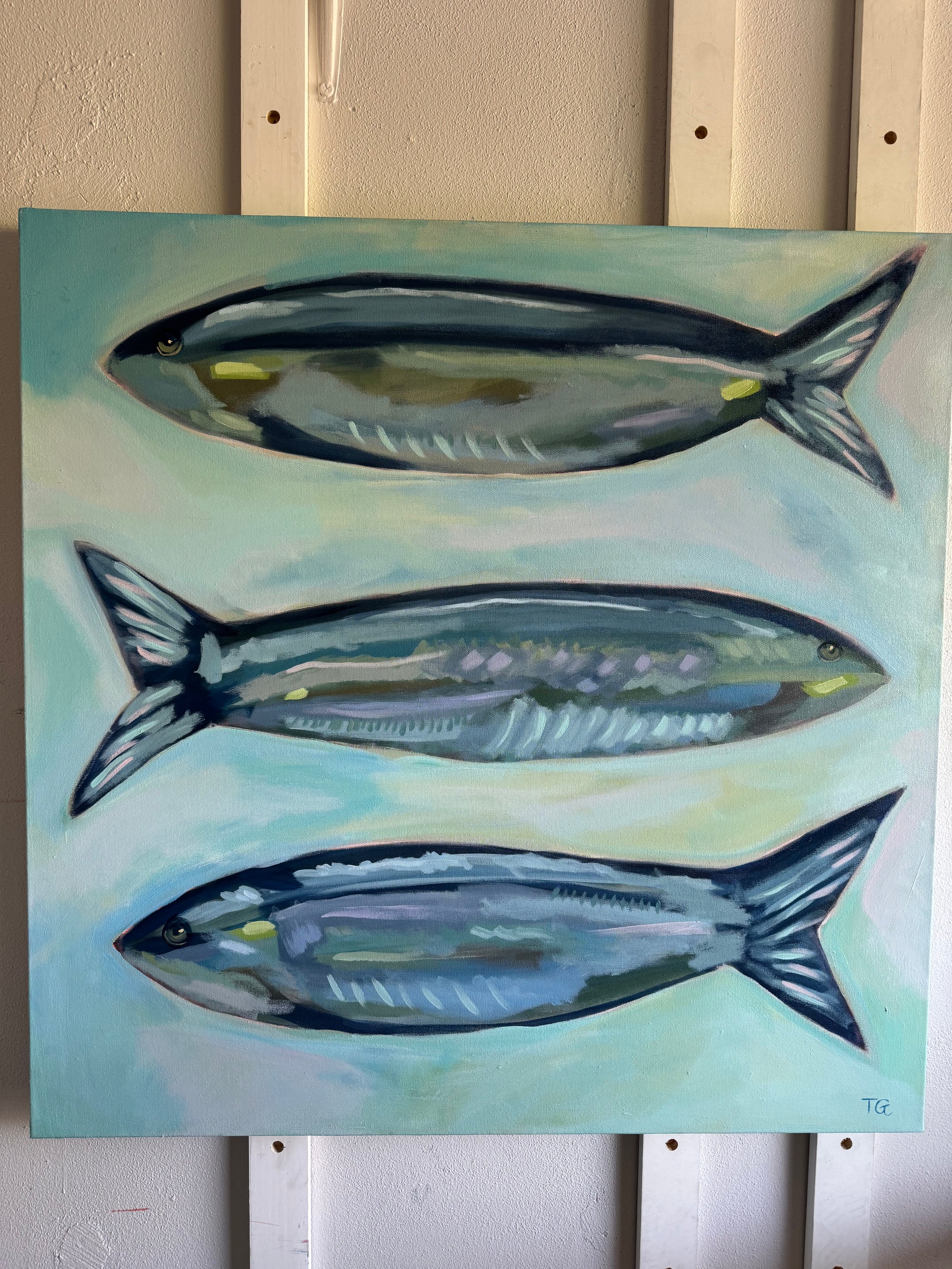 Painting of three fish on a light blue background